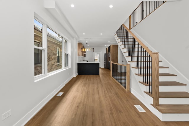 8114 S Paxton Ave, Chicago, IL 60617 - entrance foyer featuring stairs, wood finished floors, baseboards, and recessed lighting