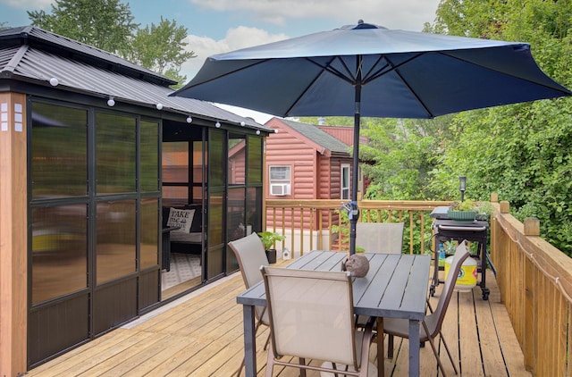 195 Fossil Cove Ln, Wilmington, IL 60481 - wooden terrace with outdoor dining area and a sunroom