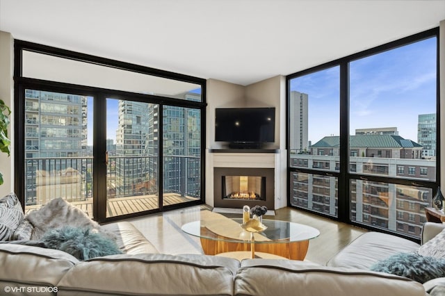 435 W Erie St Unit 1708, Chicago, IL 60654 - living room featuring floor to ceiling windows, a warm lit fireplace, and wood finished floors