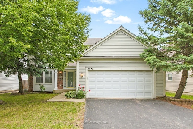 2853 Coastal Dr, Aurora, IL 60503 - view of front of house with driveway, an attached garage, a front yard, and brick siding