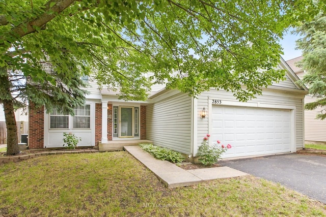 2853 Coastal Dr, Aurora, IL 60503 - view of front of house featuring asphalt driveway, a garage, a front yard, and brick siding