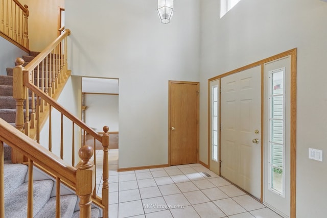 2853 Coastal Dr, Aurora, IL 60503 - entrance foyer with healthy amount of natural light, a high ceiling, stairway, and light tile patterned floors