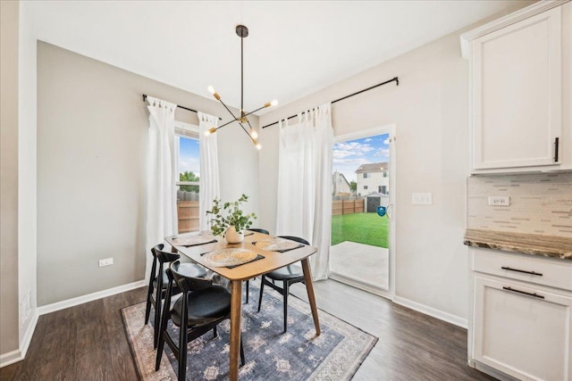 26143 S White Oak Trl, Channahon, IL 60410 - dining room with a chandelier, dark wood finished floors, and baseboards