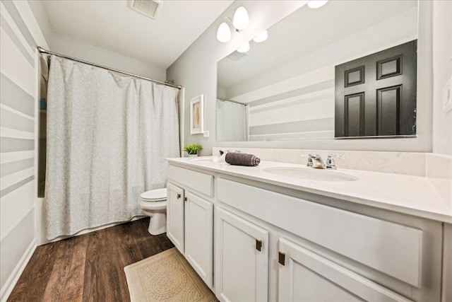26143 S White Oak Trl, Channahon, IL 60410 - bathroom with double vanity, wood finished floors, toilet, and shower / tub combo with curtain