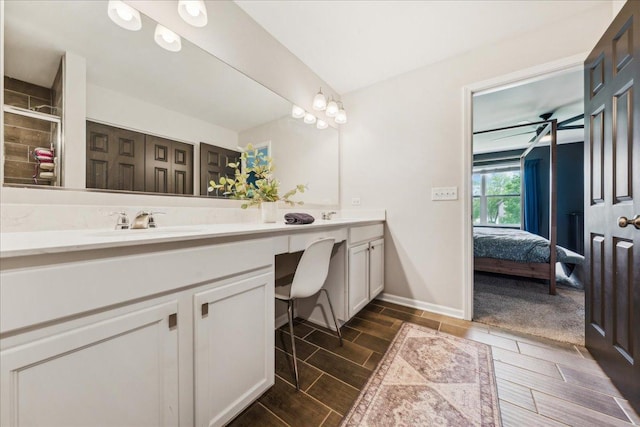 26143 S White Oak Trl, Channahon, IL 60410 - full bath featuring double vanity, connected bathroom, wood tiled floors, a tile shower, and baseboards