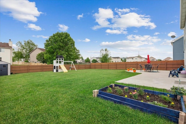 26143 S White Oak Trl, Channahon, IL 60410 - view of yard featuring a playground, a patio, a vegetable garden, and a storage unit