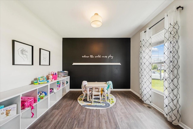 26143 S White Oak Trl, Channahon, IL 60410 - game room with wood finished floors, baseboards, and an accent wall