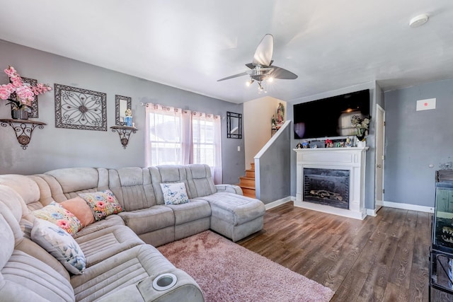 5844 W Maple Ave, Berkeley, IL 60163 - living room with dark wood-style flooring, a ceiling fan, a glass covered fireplace, and baseboards