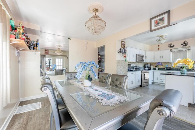 5844 W Maple Ave, Berkeley, IL 60163 - dining space featuring a chandelier and light wood finished floors