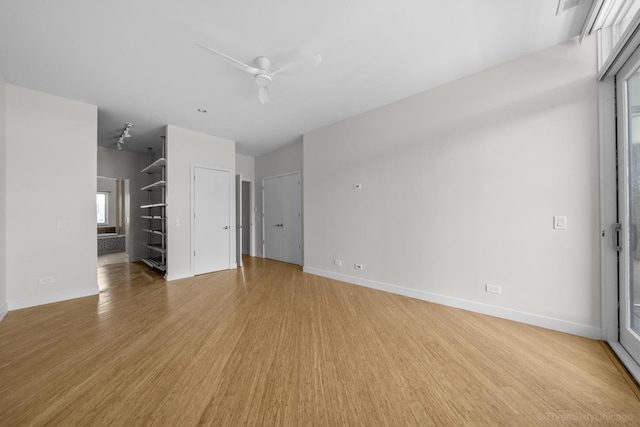 1322 N Clybourn Ave Unit 4S, Chicago, IL 60610 - spare room featuring light wood-type flooring, a ceiling fan, and baseboards