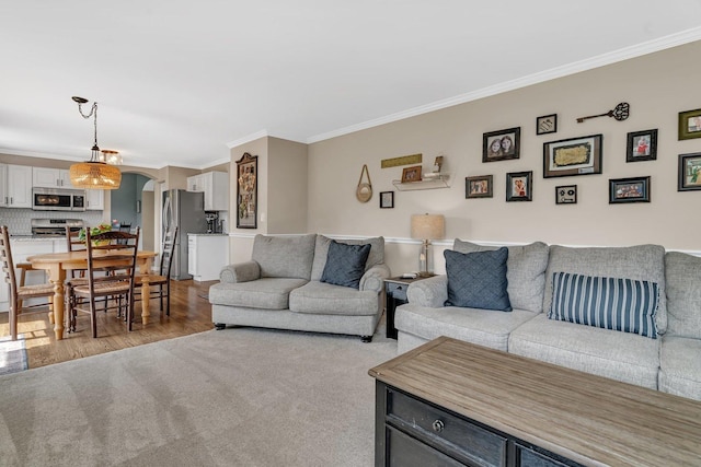 633 Salem Cir, Oswego, IL 60543 - living area with crown molding, arched walkways, and wood finished floors