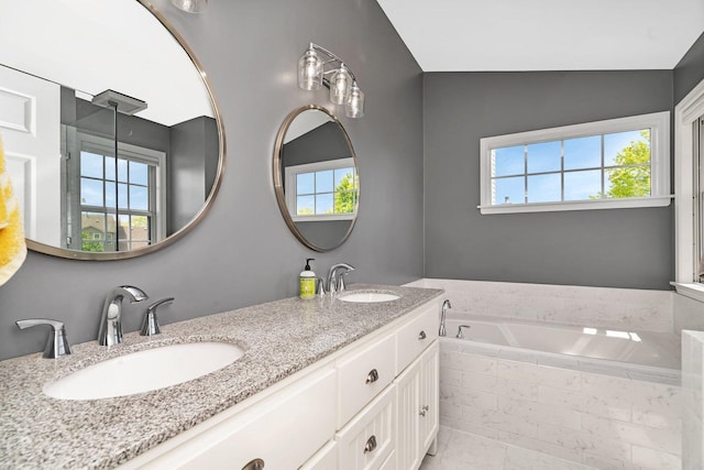633 Salem Cir, Oswego, IL 60543 - full bathroom with double vanity, plenty of natural light, and a bath