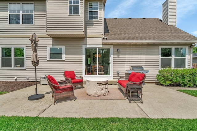 633 Salem Cir, Oswego, IL 60543 - back of property featuring roof with shingles, a patio area, a chimney, and an outdoor hangout area