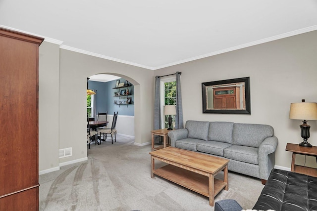 633 Salem Cir, Oswego, IL 60543 - living room with arched walkways, ornamental molding, baseboards, and light colored carpet