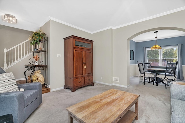 633 Salem Cir, Oswego, IL 60543 - living area featuring arched walkways, light colored carpet, crown molding, stairway, and baseboards