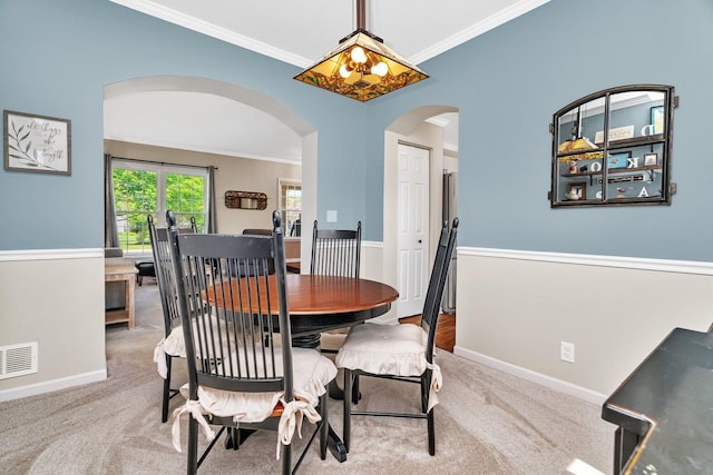 633 Salem Cir, Oswego, IL 60543 - dining area with arched walkways, crown molding, baseboards, and carpet