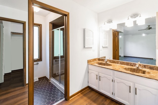 26 Marina Dr, Des Plaines, IL 60016 - bathroom with double vanity, a stall shower, wood finished floors, and a ceiling fan