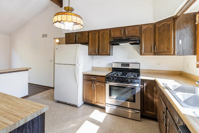 26 Marina Dr, Des Plaines, IL 60016 - kitchen featuring freestanding refrigerator, stainless steel gas stove, under cabinet range hood, light countertops, and a sink