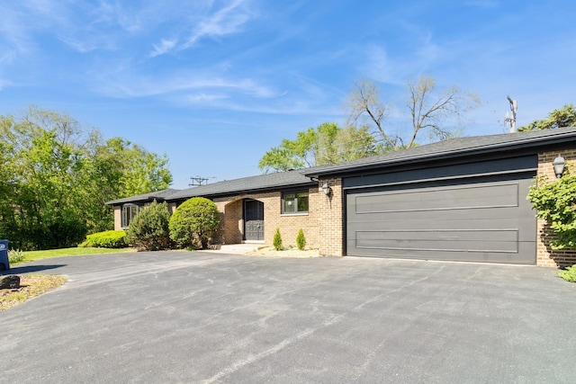 26 Marina Dr, Des Plaines, IL 60016 - ranch-style house featuring asphalt driveway, brick siding, an attached garage, and roof with shingles