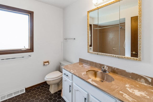 26 Marina Dr, Des Plaines, IL 60016 - full bathroom with vanity, toilet, tiled shower, and baseboards