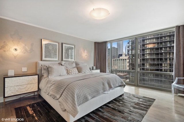 2 E Erie St Unit 1605, Chicago, IL 60611 - bedroom with a view of city, hardwood / wood-style floors, access to exterior, and a wall of windows