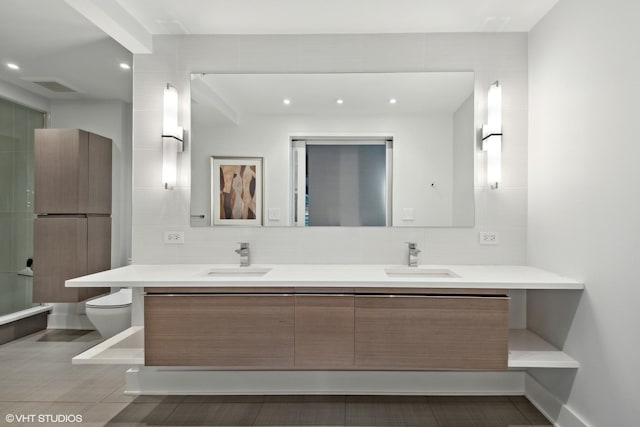 2 E Erie St Unit 1605, Chicago, IL 60611 - bathroom with double vanity, toilet, tasteful backsplash, and recessed lighting