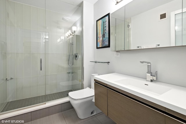 2 E Erie St Unit 1605, Chicago, IL 60611 - bathroom featuring toilet, a shower stall, vanity, and tile patterned flooring
