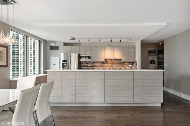 2 E Erie St Unit 1605, Chicago, IL 60611 - kitchen with appliances with stainless steel finishes, washer / clothes dryer, modern cabinets, light countertops, and backsplash