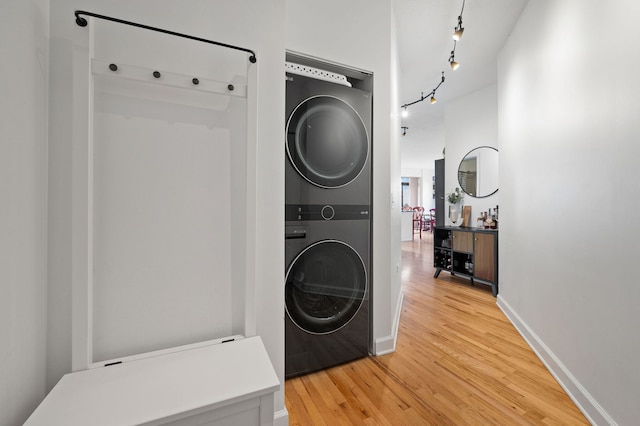 1529 S State St Unit 13G, Chicago, IL 60605 - laundry area with estacked washer and dryer, light wood finished floors, rail lighting, and baseboards