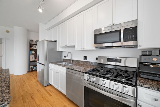 1529 S State St Unit 13G, Chicago, IL 60605 - kitchen with appliances with stainless steel finishes, a sink, white cabinetry, light wood-style floors, and dark stone countertops