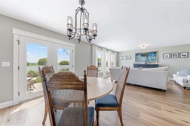 15905 Rolland Dr, Manhattan, IL 60442 - dining space featuring a chandelier, french doors, light wood-style flooring, and baseboards