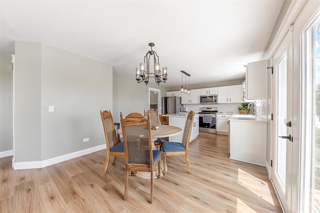 15905 Rolland Dr, Manhattan, IL 60442 - dining area with a chandelier, light wood finished floors, and baseboards