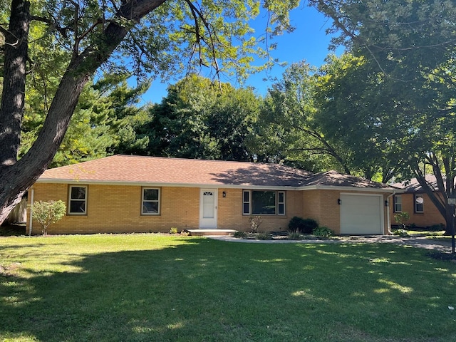 1808 Bellamy Dr, Champaign, IL 61821 - ranch-style home with a garage, brick siding, and a front lawn