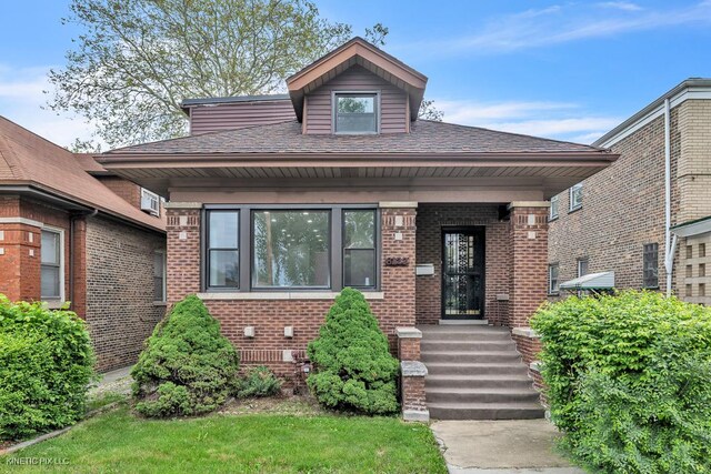 8127 S Jeffery Blvd, Chicago, IL 60617 - view of front facade with brick siding and roof with shingles