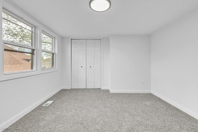 8127 S Jeffery Blvd, Chicago, IL 60617 - unfurnished bedroom featuring carpet, baseboards, and a closet
