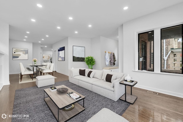 8127 S Jeffery Blvd, Chicago, IL 60617 - living area with wood finished floors, recessed lighting, and baseboards