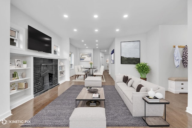 8127 S Jeffery Blvd, Chicago, IL 60617 - living area with built in features, a fireplace, recessed lighting, and wood finished floors