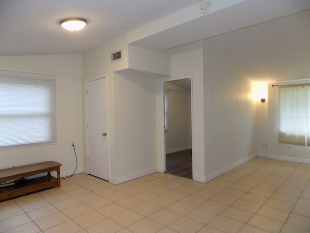 7818 Mildred Rd, Machesney Park, IL 61115 - spare room with baseboards, vaulted ceiling, and a smoke detector