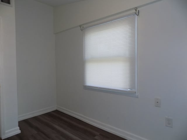 7818 Mildred Rd, Machesney Park, IL 61115 - unfurnished room featuring dark wood-type flooring and baseboards