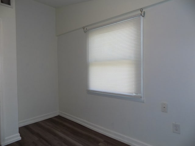 7818 Mildred Rd, Machesney Park, IL 61115 - unfurnished room featuring dark wood-type flooring and baseboards