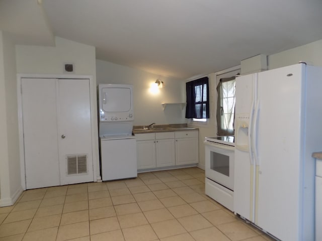7818 Mildred Rd, Machesney Park, IL 61115 - kitchen featuring white appliances, stacked washer / drying machine, vaulted ceiling, white cabinetry, and a sink