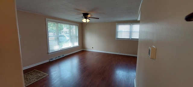 8923 S Main St, Hometown, IL 60456 - empty room featuring plenty of natural light, ceiling fan, dark wood-style flooring, crown molding, and baseboards