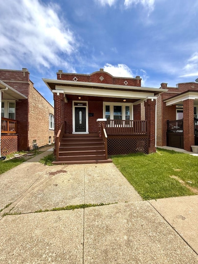 1435 S 57th Ave, Cicero, IL 60804 - bungalow-style house featuring a porch, brick siding, and a front lawn
