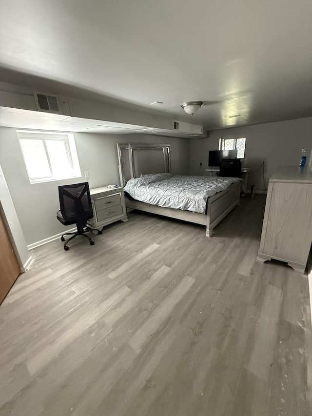 1435 S 57th Ave, Cicero, IL 60804 - bedroom featuring light wood-style floors, multiple windows, baseboards, and a desk