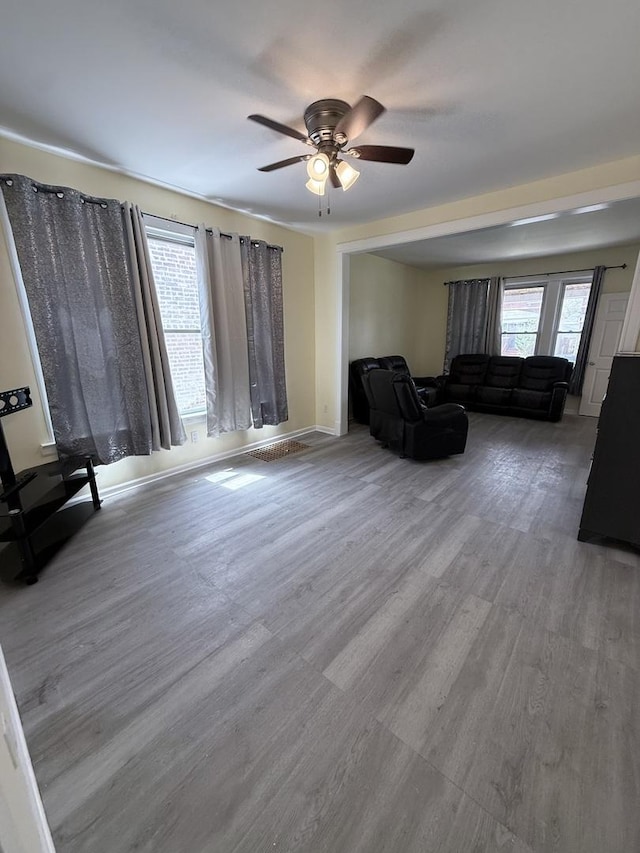 1435 S 57th Ave, Cicero, IL 60804 - living room featuring ceiling fan, baseboards, and wood finished floors