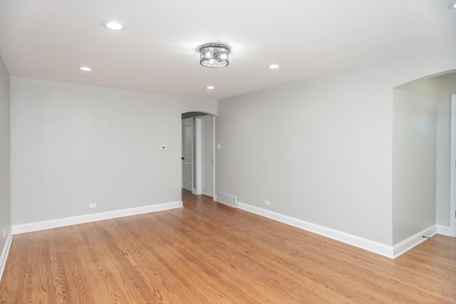 2101 W 82nd Pl, Chicago, IL 60620 - empty room with arched walkways, light wood-style flooring, baseboards, and recessed lighting