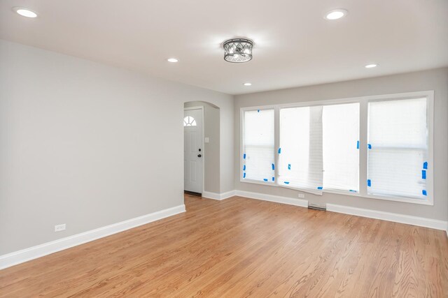 2101 W 82nd Pl, Chicago, IL 60620 - spare room with arched walkways, baseboards, recessed lighting, and light wood finished floors
