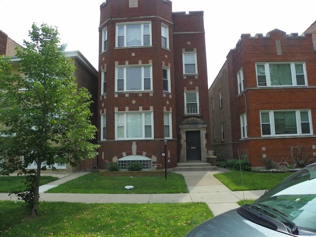 8223 S Langley Ave, Chicago, IL 60619 - view of front of home featuring brick siding and a front lawn
