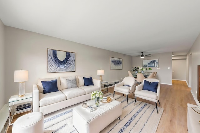 1320B Lore Ln Unit 117, Lombard, IL 60148 - living room featuring light wood-style flooring, baseboards, and a ceiling fan