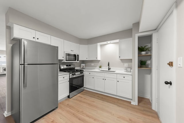 1320B Lore Ln Unit 117, Lombard, IL 60148 - kitchen with stainless steel appliances, a sink, white cabinetry, light countertops, and light wood-style flooring